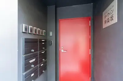 a red door in a room with dressers at \u30c0\u30fc\u30a6\u30a3\u30f3\u795e\u697d\u5742 in Tokyo