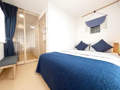 a bedroom with a blue bed and a chair at Lili House -- Serene Japanese Garden Villa,4 min to station,3 bedrooms,8people ok in Tokyo