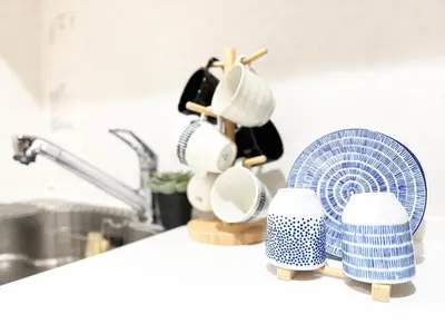 a kitchen counter with a fan and cups and a sink at Lili House -- Serene Japanese Garden Villa,4 min to station,3 bedrooms,8people ok in Tokyo