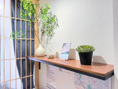 a shelf with plants and a map on a wall at Lili House -- Serene Japanese Garden Villa,4 min to station,3 bedrooms,8people ok in Tokyo