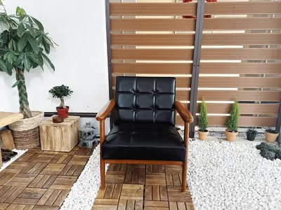 a black leather chair sitting on a patio at Lili House -- Serene Japanese Garden Villa,4 min to station,3 bedrooms,8people ok in Tokyo