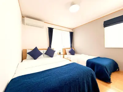 two beds in a room with blue and white at Lili House -- Serene Japanese Garden Villa,4 min to station,3 bedrooms,8people ok in Tokyo