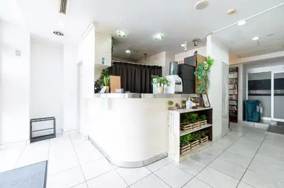 a lobby with a white counter and plants at Hotel Grand Fort - Vacation STAY 19307v in Tokyo
