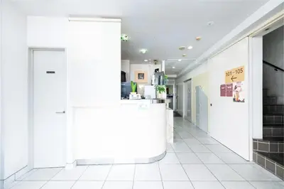 a corridor of a store with white walls and white tile floors at Hotel Grand Fort - Vacation STAY 19307v in Tokyo
