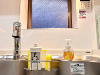 a bathroom sink with a bottle of soap and a mirror at High-end Tokyo shinjuku Central Park Flat 2 in Tokyo