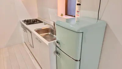 a small kitchen with a refrigerator and a sink at High-end Tokyo shinjuku Central Park Flat 2 in Tokyo