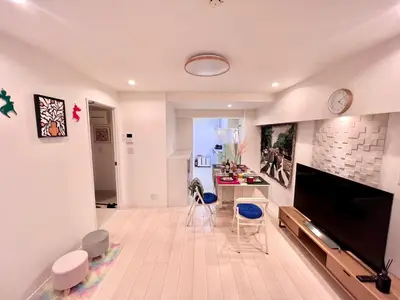 a living room with a large flat screen tv and chairs at High-end Tokyo shinjuku Central Park Flat 2 in Tokyo