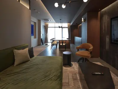a living room with a couch and a table at illi Gran Azabujuban in Tokyo