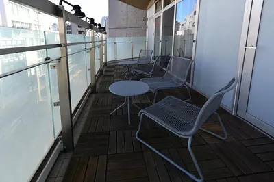 a row of chairs and a table on a balcony at illi Gran Azabujuban in Tokyo