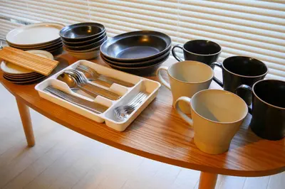 a table with plates and cups and utensils on it at #4 -\u30a8\u30af\u30bb\u30eb\u6a4b\u7acb102- Entire Unit in Tokyo