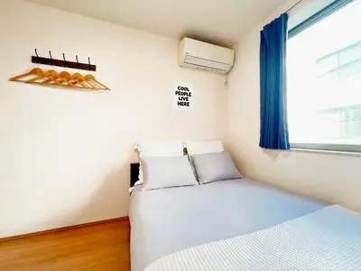 a small bedroom with a bed and a window at Ueno Cozy Loft Apt Free WiFi in Tokyo