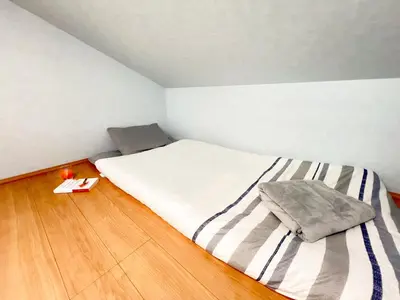 a small bedroom with a bed and a wooden floor at Ueno Cozy Loft Apt Free WiFi in Tokyo