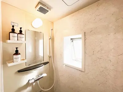 a bathroom with a sink and a mirror and a window at Ueno Cozy Loft Apt Free WiFi in Tokyo