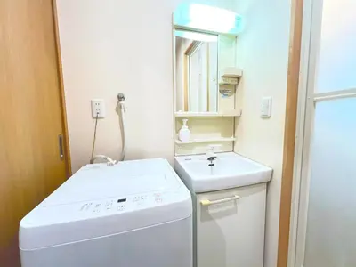 a small bathroom with a washing machine and a sink at Ueno Cozy Loft Apt Free WiFi in Tokyo
