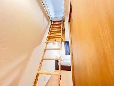 a ladder leading up to a room with a window at Ueno Cozy Loft Apt Free WiFi in Tokyo