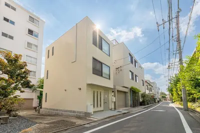 a white building on the side of a street at \u4ee3\u3005\u6728\u4e0a\u539f in Tokyo