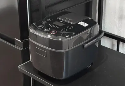 a cell phone sitting on top of a stove at \u4ee3\u3005\u6728\u4e0a\u539f in Tokyo