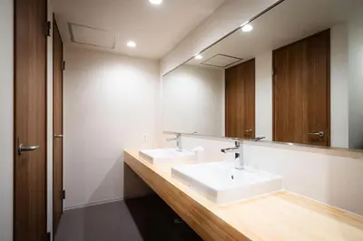 a bathroom with two sinks and a large mirror at MANGA ART HOTEL, BAKUROCHO - Vacation STAY 24887v in Tokyo