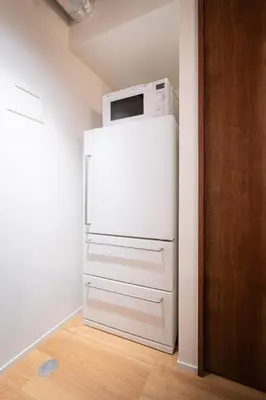 a white refrigerator with a microwave on top of it at MANGA ART HOTEL, BAKUROCHO - Vacation STAY 24863v in Tokyo