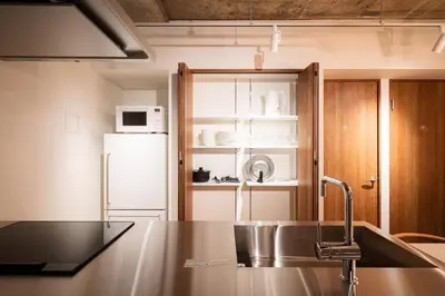 a kitchen with a sink and a refrigerator at MANGA ART HOTEL, BAKUROCHO - Vacation STAY 24863v in Tokyo