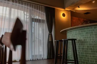 a shadow of a person standing in front of a window at THE HOTEL of TOKYO Akasaka in Tokyo