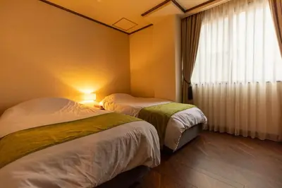a hotel room with two beds and a window at THE HOTEL of TOKYO Akasaka in Tokyo