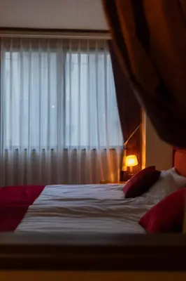 a bedroom with a bed with a large window at THE HOTEL of TOKYO Akasaka in Tokyo