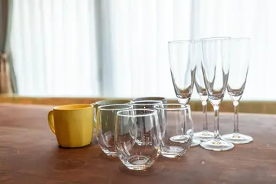 a group of wine glasses sitting on a wooden table at THE HOTEL of TOKYO Akasaka in Tokyo