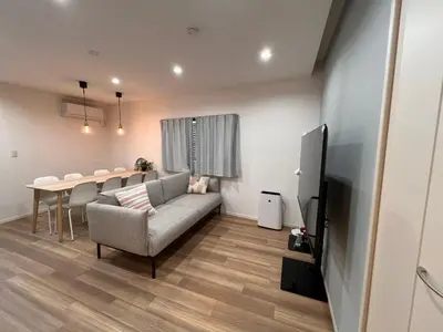 a living room with a couch and a table at \u62bc\u4e0aSkytree Oshiage Hostel-KT0032 in Tokyo