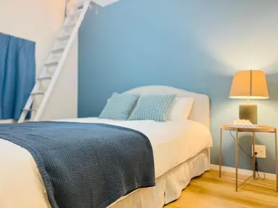 a blue bedroom with a bed and a ladder at Ueno Minowa House -TT0398 in Tokyo