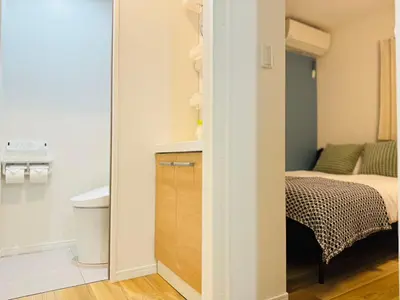 a room with a bedroom with a bed and a closet at Ueno Minowa House -TT0398 in Tokyo