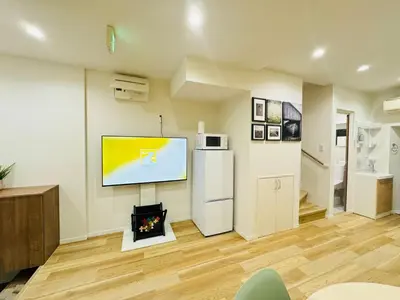 a living room with a flat screen tv on a wall at Ueno Minowa House -TT0398 in Tokyo