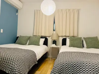 two beds sitting next to each other in a room at Ueno Minowa House -TT0398 in Tokyo