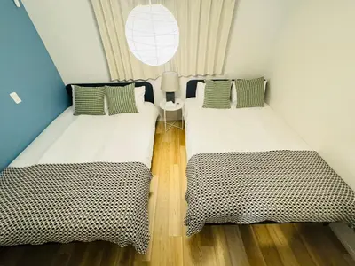 two twin beds in a small room with at Ueno Minowa House -TT0398 in Tokyo