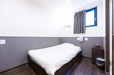 a small bed in a room with a window at Hotel Grand Fort - Vacation STAY 41993v in Tokyo