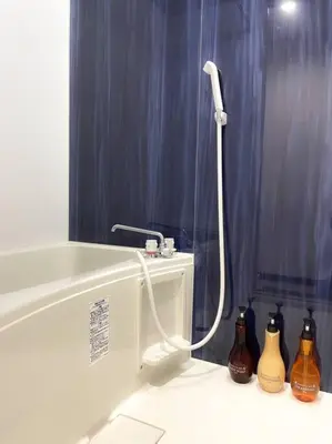 a bathroom with a bath tub with bottles on the floor at 303 Oshiage sta 3mins walk! Wi-Fi Elevator 4pax in Tokyo