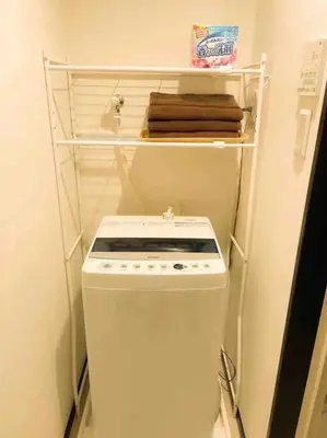 a small kitchen with a white stove and a shelf at 303 Oshiage sta 3mins walk! Wi-Fi Elevator 4pax in Tokyo