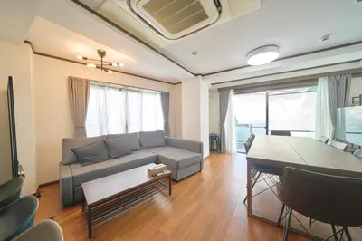 a living room with a couch and a table at FINOA Residential Suite Kamata in Tokyo