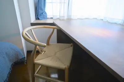 a chair sitting in front of a wooden desk at FINOA Residential Suite Kamata in Tokyo