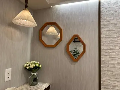 a bathroom with two mirrors and a vase of flowers at \u6da9\u8c37\u6c11\u5bbf in Tokyo