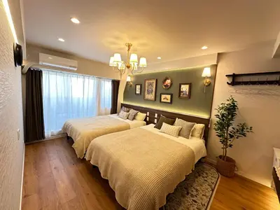 a bedroom with two beds and a window at \u6da9\u8c37\u6c11\u5bbf in Tokyo