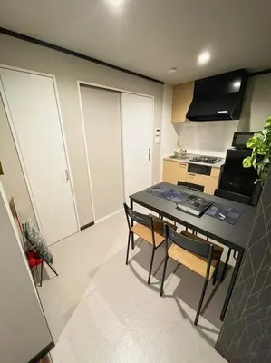 a kitchen with a table and chairs in a room at \u30a2\u30f3\u30c9\u30b9\u30c6\u30a4\u84b2\u75301\u4e01\u76ee in Tokyo
