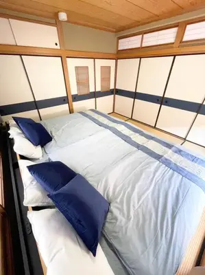 a large bed on a boat with blue pillows at \u30a2\u30f3\u30c9\u30b9\u30c6\u30a4\u84b2\u75301\u4e01\u76ee in Tokyo