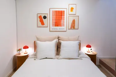 a bedroom with a white bed with two lamps at Ken's Place Omotesando in Tokyo