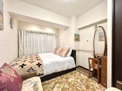 a small bedroom with a bed and a mirror at Ikebukuro 606 -TS0043 in Tokyo