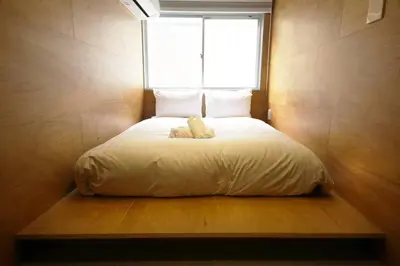 a bed in a room with a window at \u3077\u3075\u304b\u5c0f\u6751\u4e95 - Pufuka Omurai in Tokyo