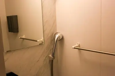 a bathroom with a mirror and a shower stall at \u3077\u3075\u304b\u5c0f\u6751\u4e95 - Pufuka Omurai in Tokyo