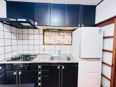 a small kitchen with a sink and a refrigerator at NN-Ōjihonchō-House-KI0174 in Tokyo