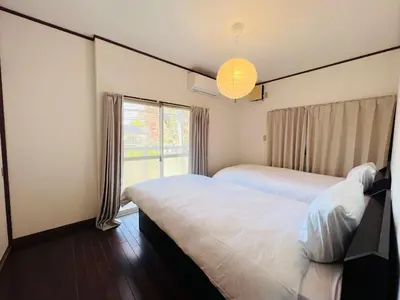 a bedroom with two beds and a window at NN-Ōjihonchō-House-KI0174 in Tokyo