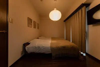 a small bedroom with a bed and a chandelier at Villa mitamura301VM31 in Tokyo
